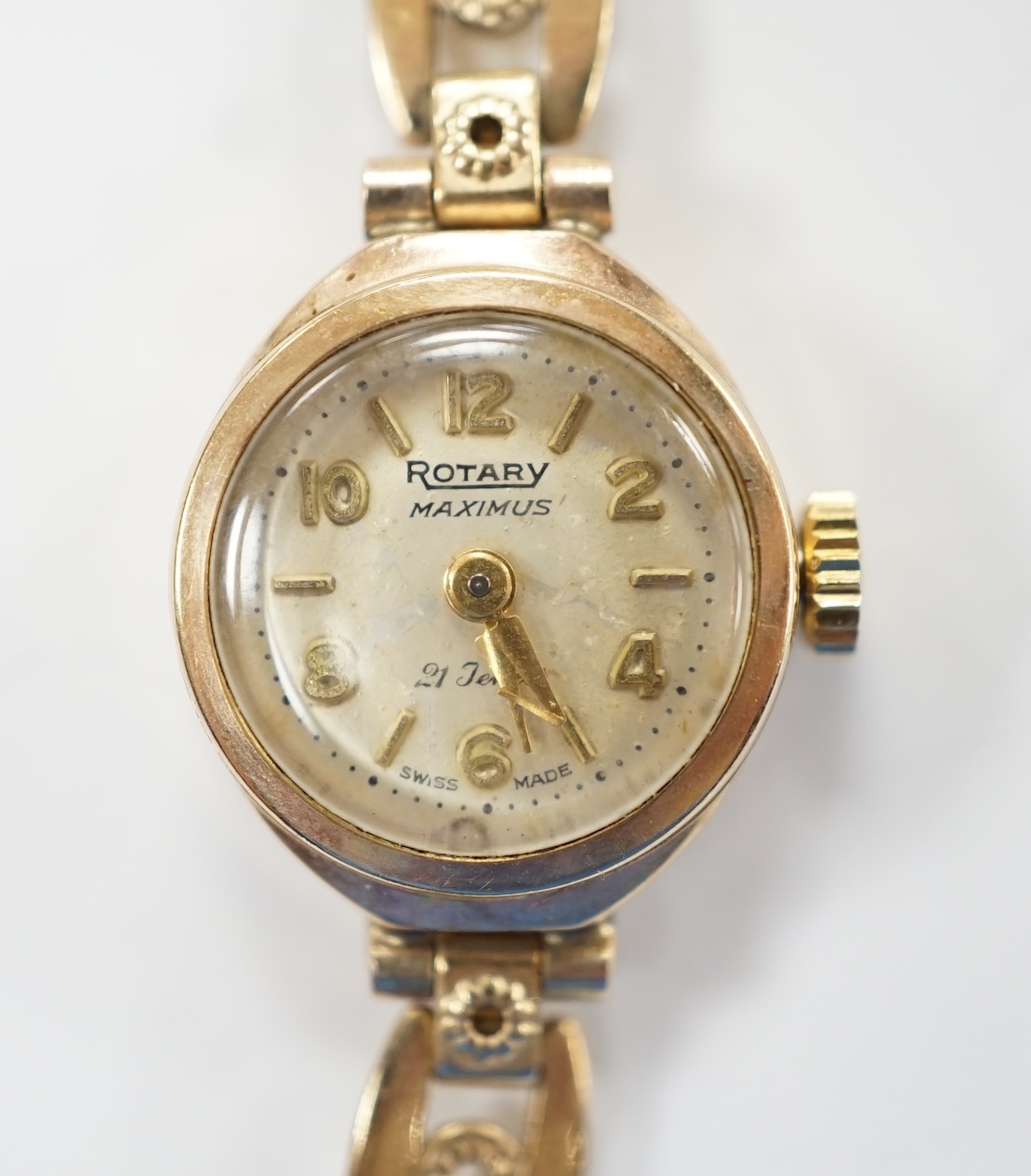 A lady's 9ct gold Rotary Maximus manual wind wrist watch, on a rolled gold bracelet. Fair condition.